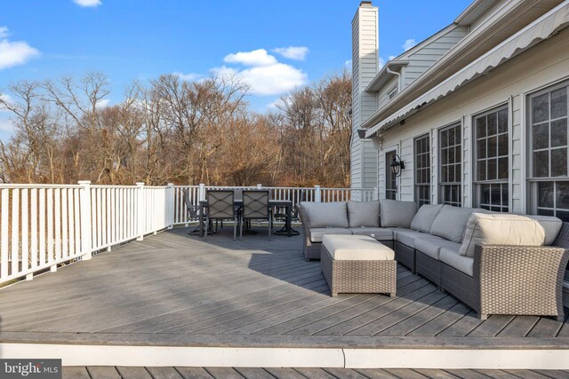 deck with an outdoor living space and outdoor dining area