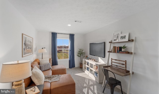 living area featuring a textured ceiling and light colored carpet