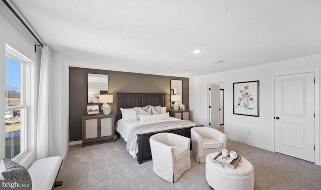 carpeted bedroom featuring a textured ceiling