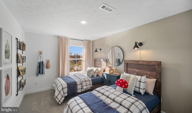 bedroom with carpet and a textured ceiling