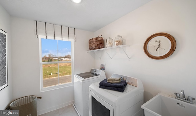 laundry area with sink, light tile patterned flooring, and washer and dryer