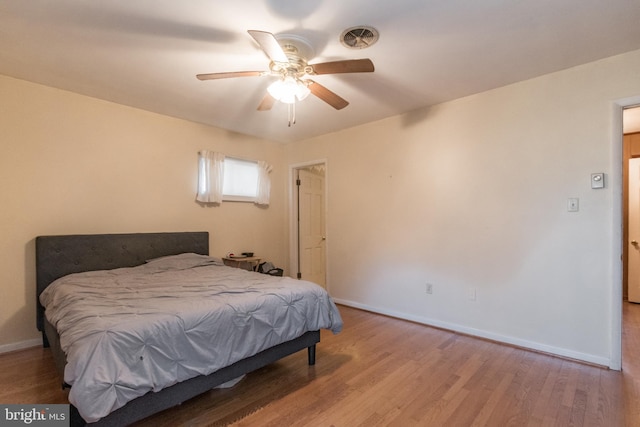 bedroom with ceiling fan and light hardwood / wood-style flooring