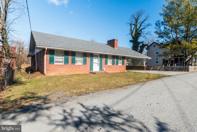 ranch-style house with a front lawn and a carport