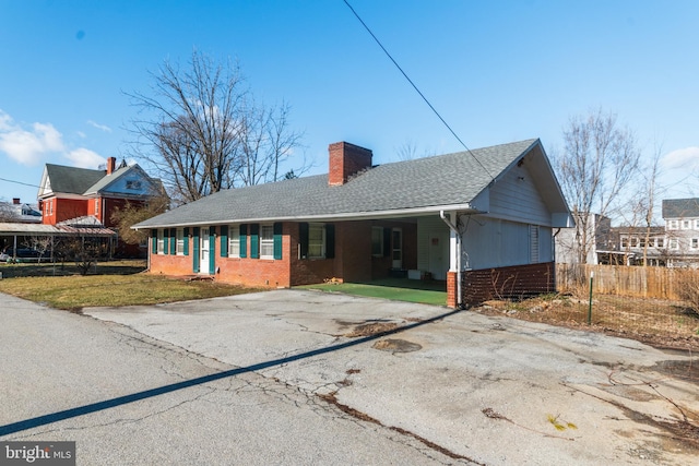 ranch-style home with a carport