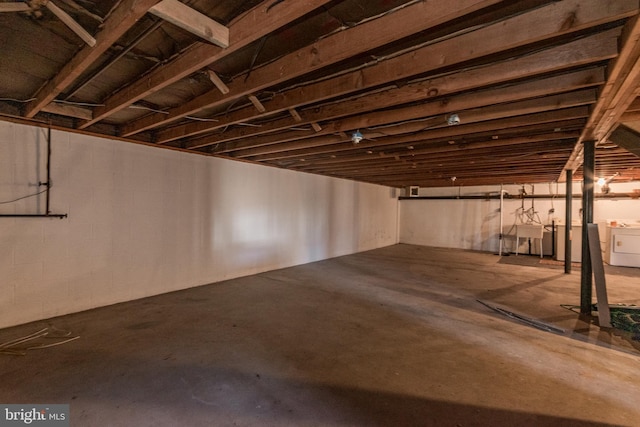 basement featuring washer and dryer and sink