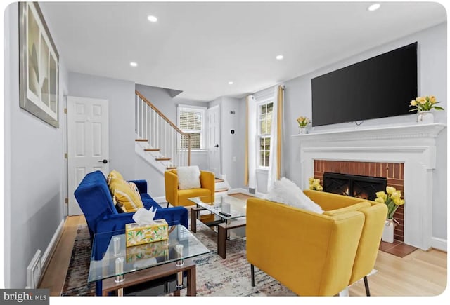 living room with a fireplace and light hardwood / wood-style floors