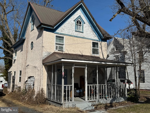 view of front facade with a sunroom