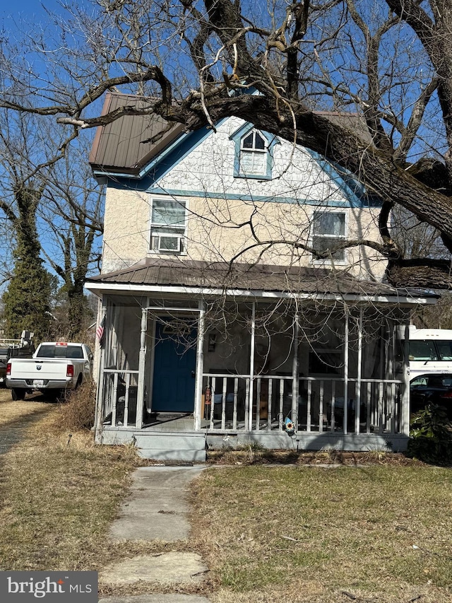 view of front of house with a porch and a front yard