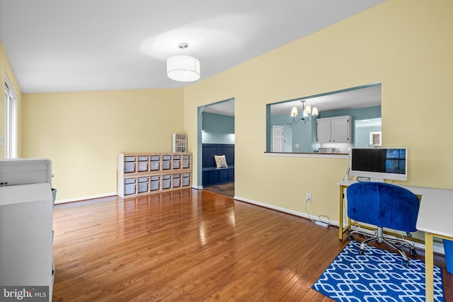 office space featuring a chandelier and wood-type flooring