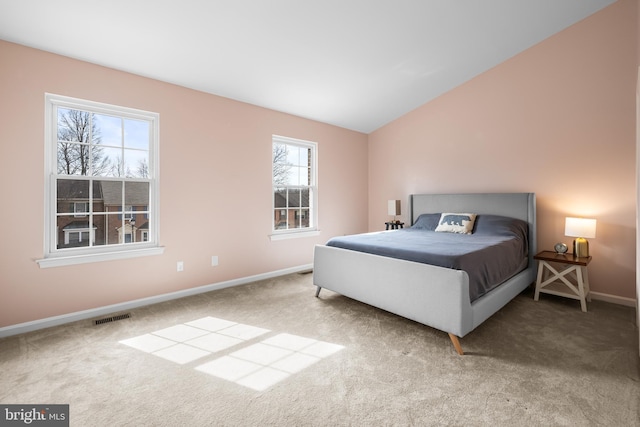 bedroom with carpet flooring and vaulted ceiling