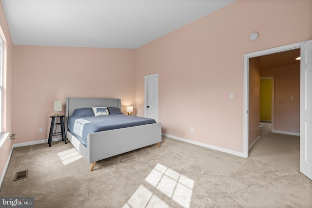 carpeted bedroom with vaulted ceiling