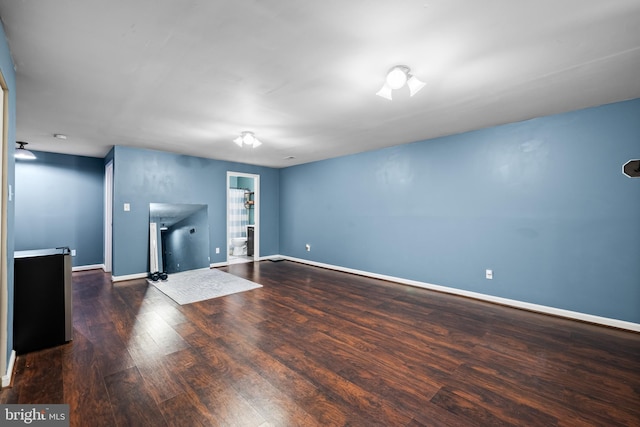 unfurnished living room featuring dark wood-type flooring