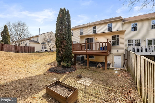 rear view of house with central AC and a deck