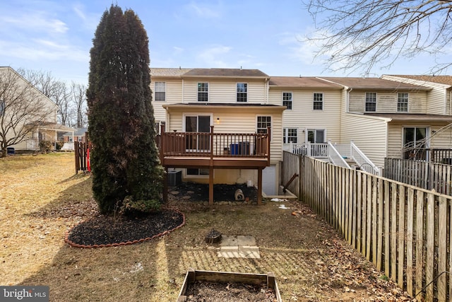 rear view of house with central AC and a wooden deck