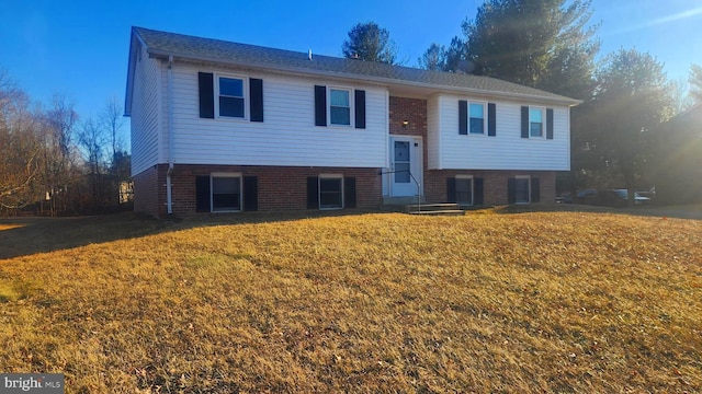 raised ranch featuring a front lawn