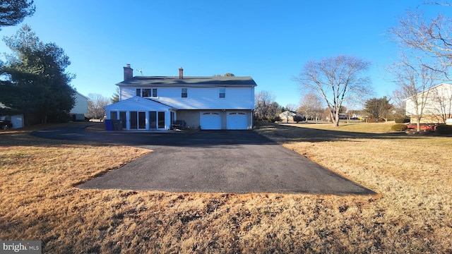 view of front facade with a front yard and a garage