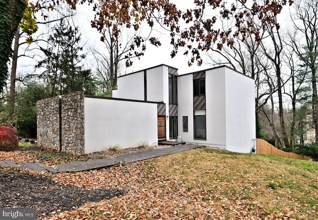 view of front of home with fence and stucco siding