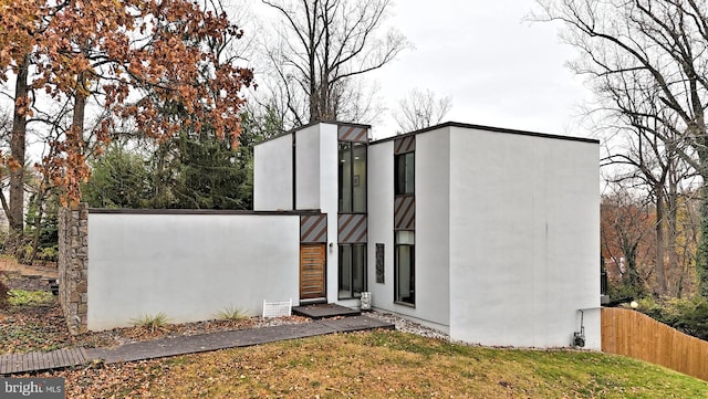 exterior space featuring fence and stucco siding