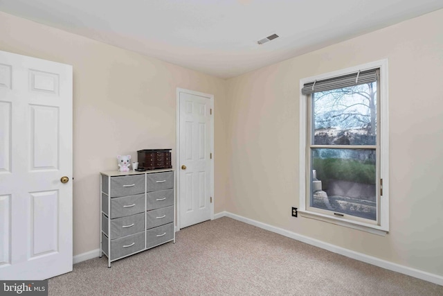 carpeted bedroom with visible vents and baseboards