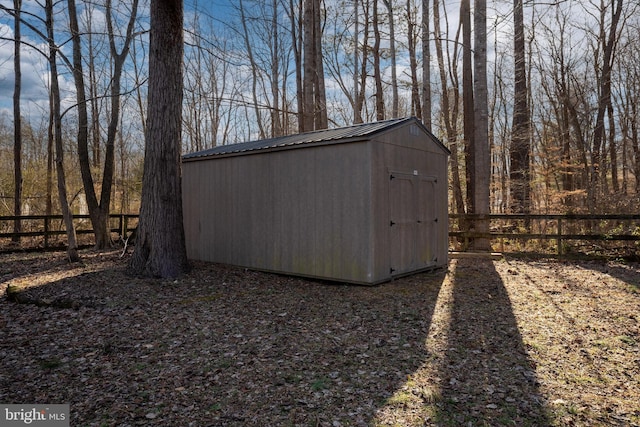 view of shed featuring fence