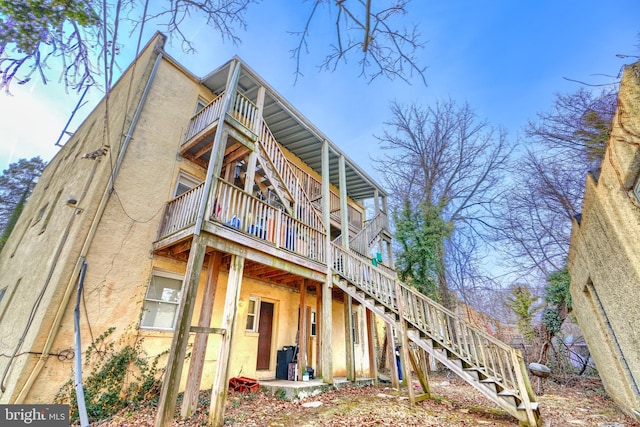 rear view of property with a balcony