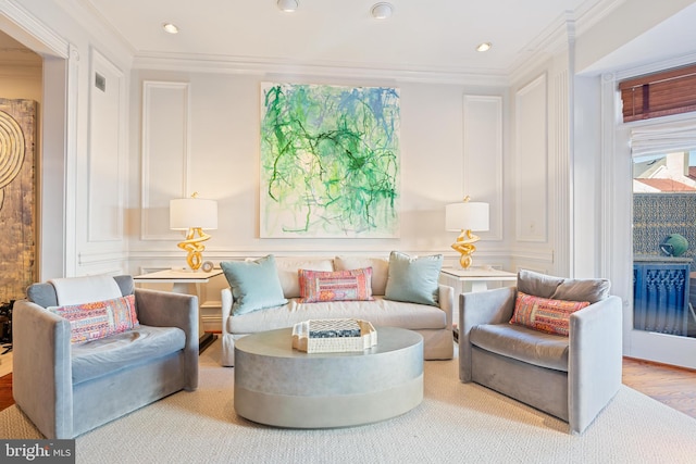 living area featuring ornamental molding and hardwood / wood-style floors