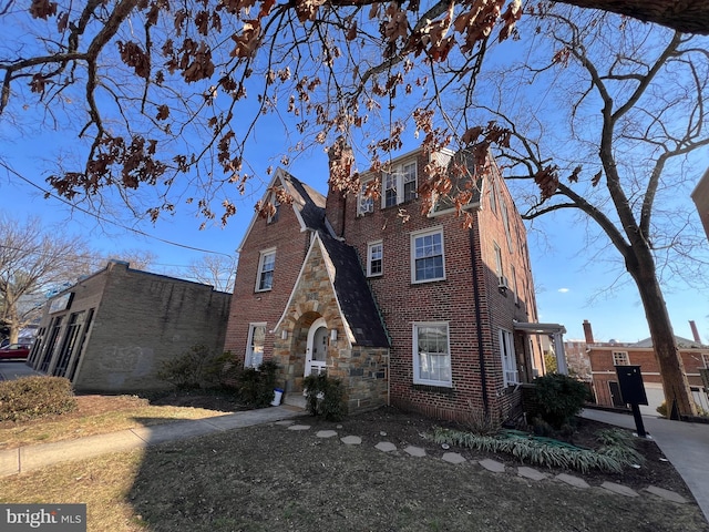 view of front of home featuring brick siding and stone siding