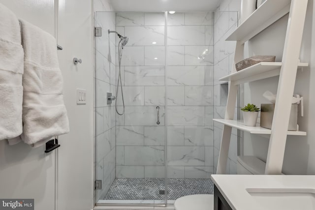 full bathroom with toilet, a shower stall, and vanity