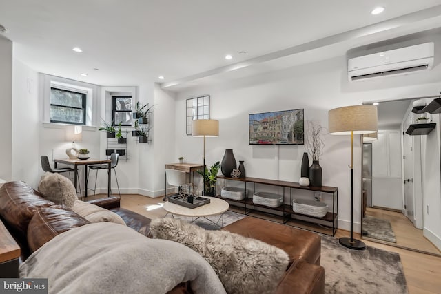 living room with plenty of natural light, a wall mounted air conditioner, wood finished floors, and recessed lighting