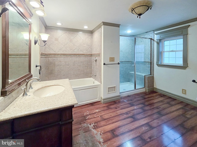 bathroom featuring vanity, independent shower and bath, crown molding, and wood-type flooring