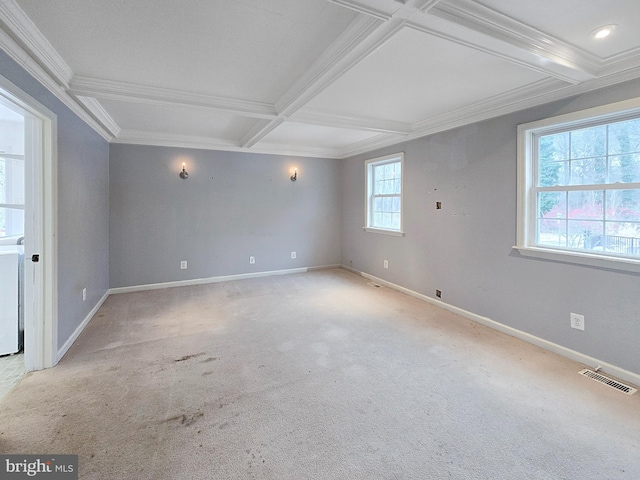 carpeted spare room with beam ceiling, washer / clothes dryer, crown molding, and coffered ceiling