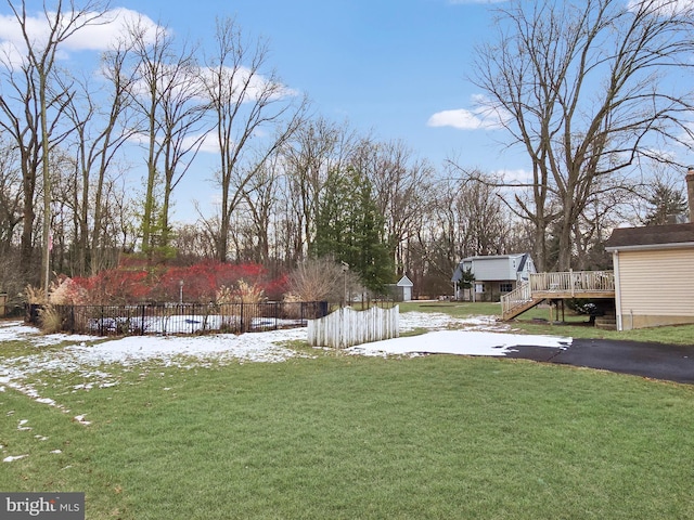 snowy yard featuring a deck