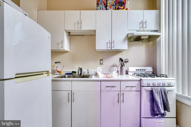 kitchen with white appliances, white cabinetry, and sink