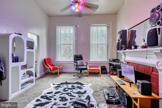 living area featuring carpet flooring and ceiling fan