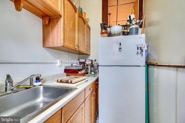 kitchen featuring white fridge and sink