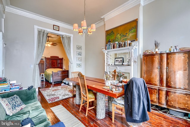 dining room featuring hardwood / wood-style flooring, crown molding, and a chandelier