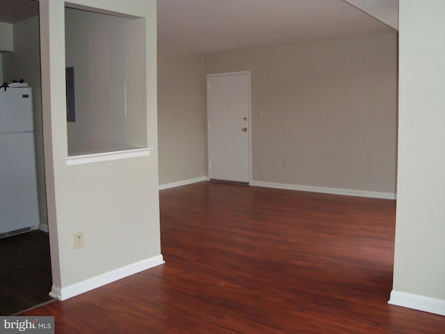 empty room featuring baseboards and wood finished floors