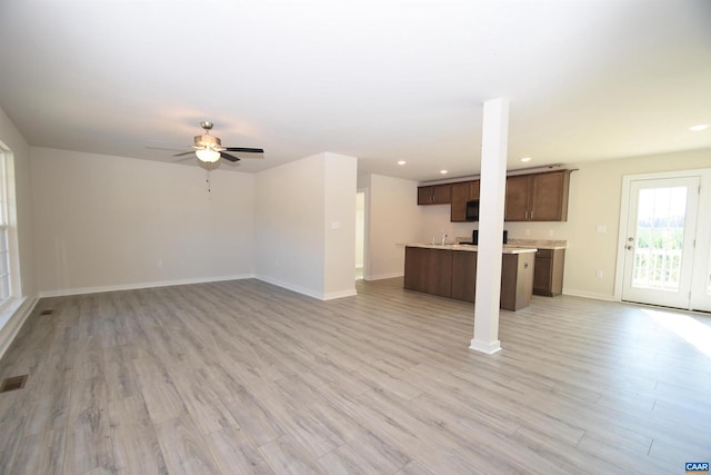 unfurnished living room with light hardwood / wood-style floors and ceiling fan