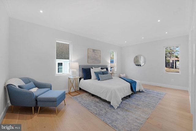 bedroom featuring recessed lighting, multiple windows, light wood-style flooring, and baseboards