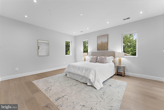 bedroom featuring recessed lighting, light wood-type flooring, visible vents, and baseboards