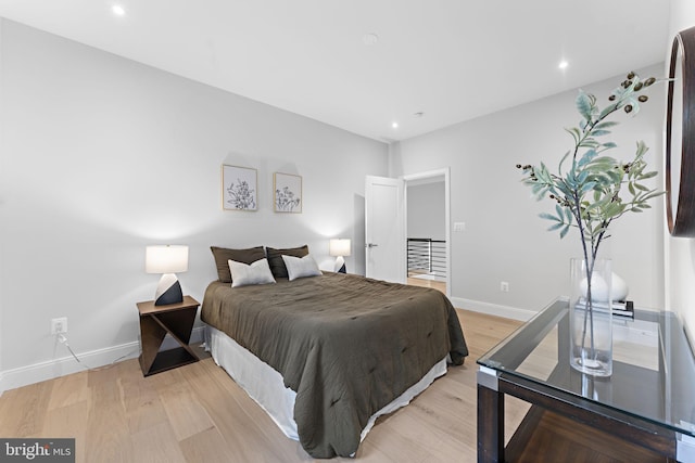 bedroom featuring light wood-style flooring, baseboards, and recessed lighting