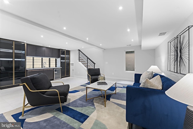 living room with stairs, baseboards, visible vents, and recessed lighting