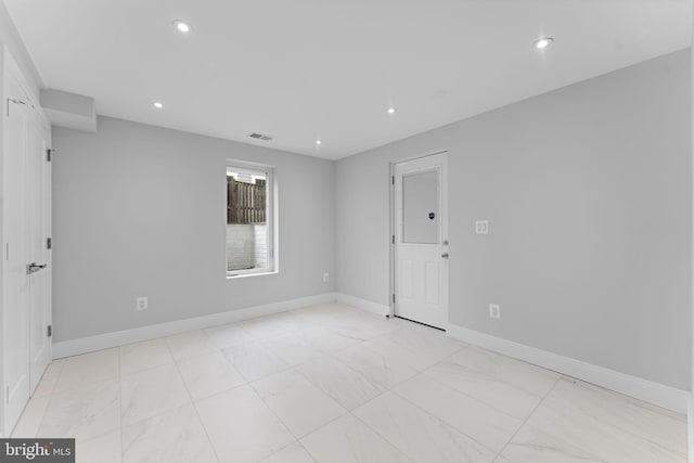 unfurnished room with baseboards, visible vents, and recessed lighting