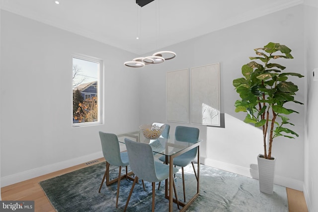 dining area with wood finished floors and baseboards