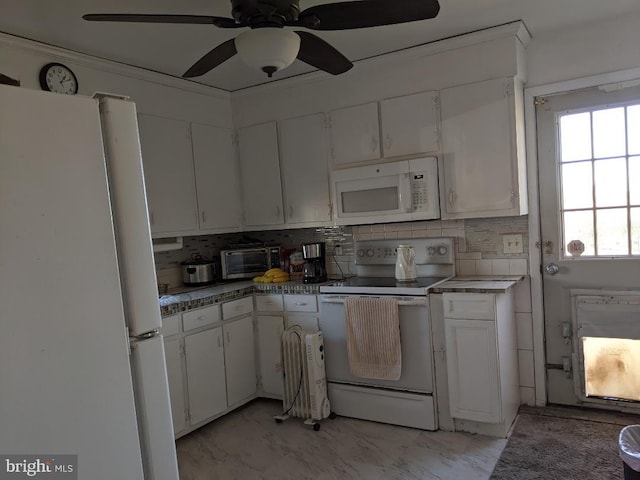 kitchen with white appliances, white cabinets, and tasteful backsplash