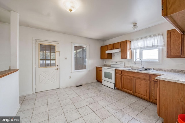 kitchen with light tile patterned flooring, sink, and white electric stove