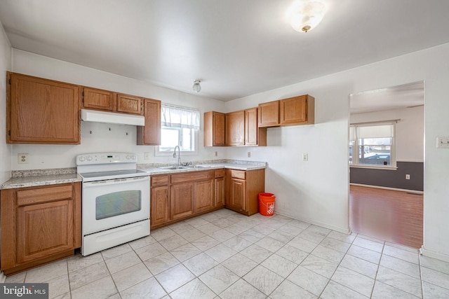 kitchen featuring sink, white electric stove, and light tile patterned floors