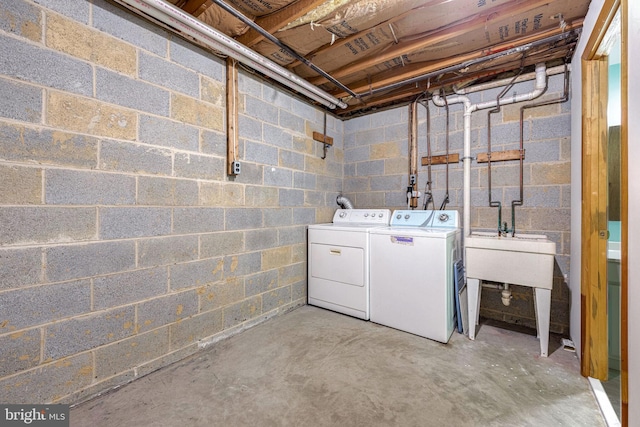 clothes washing area with washer and clothes dryer