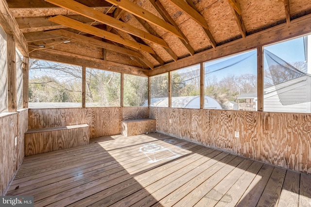 unfurnished sunroom featuring lofted ceiling