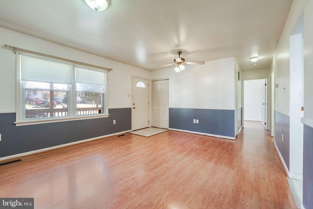 spare room featuring ceiling fan and light wood-type flooring